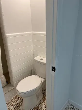 a white toilet sitting next to a bathroom sink