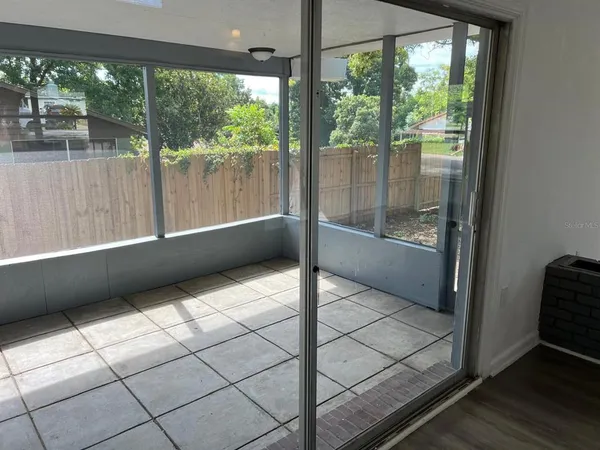 a bathroom with a bathtub and large window