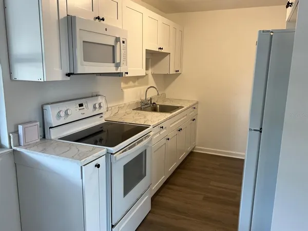 a kitchen with a sink stove and cabinets