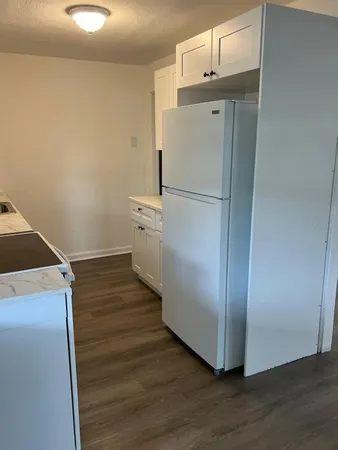 a room with wooden floor and electronic appliances