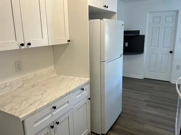 a kitchen with a refrigerator and cabinets
