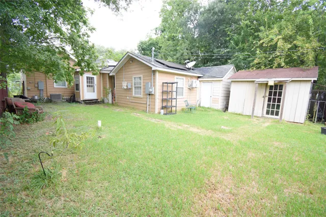 a view of a house with a yard and sitting area