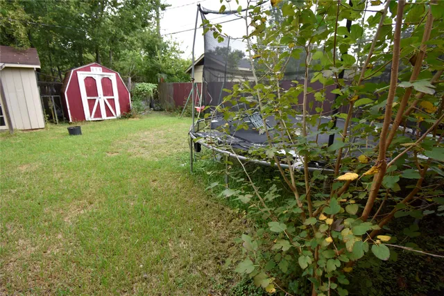 a sign that is sitting in front of a tree