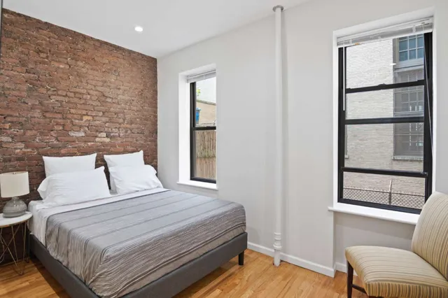 a bedroom with a bed and a couch