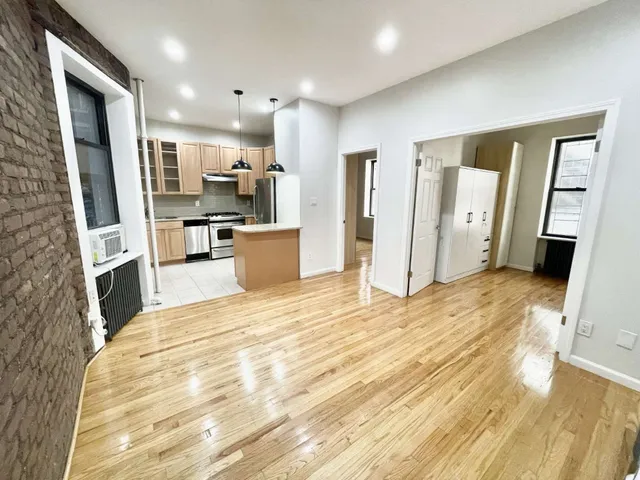 a view of kitchen with sink microwave and refrigerator