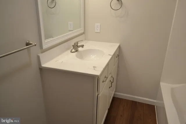 a bathroom with a sink and mirror