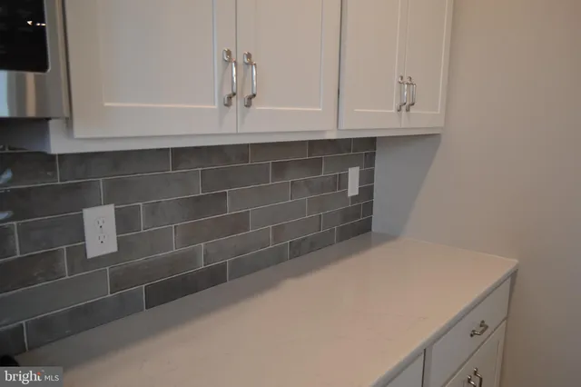 a bathroom with a sink and cabinets