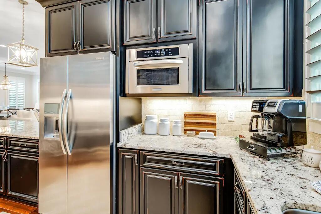 142 Matt's Way Santa Rosa Beach, FL 32459 - Photo 5 of 32 a kitchen with granite countertop a sink and stainless steel appliances