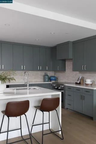 a kitchen with stainless steel appliances a sink and a stove top oven