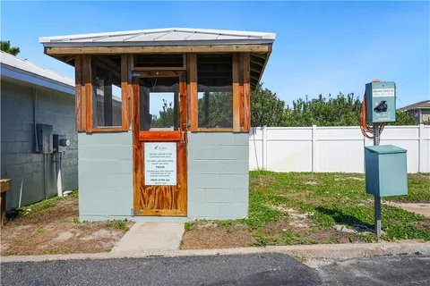 a view of a house with backyard and porch
