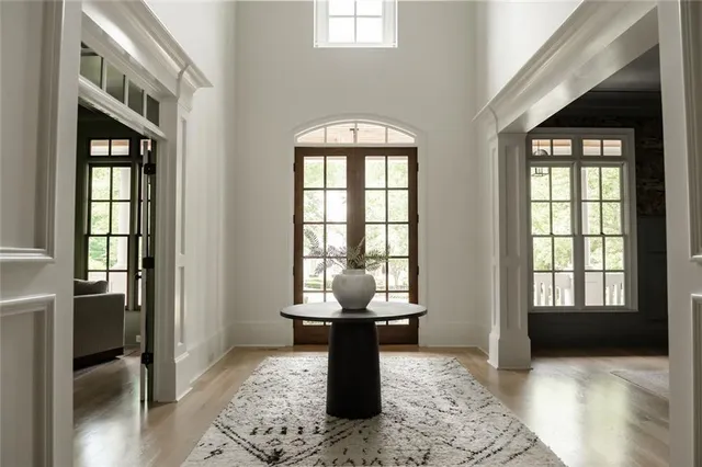 a living room with furniture a flat screen tv and a large window