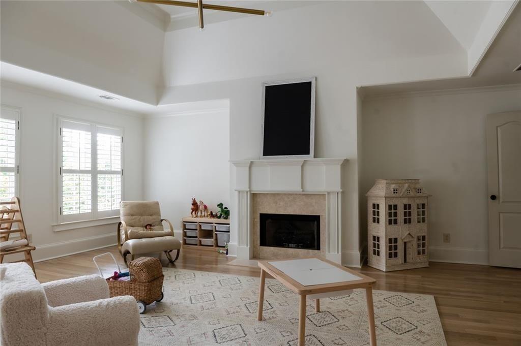 900 Crabapple Hill Alpharetta, GA 30004 - Photo 45 of 72 a living room with furniture a fireplace and a flat screen tv
