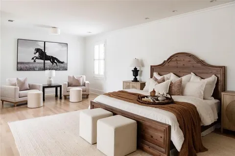 an empty room with wooden floor and entrance