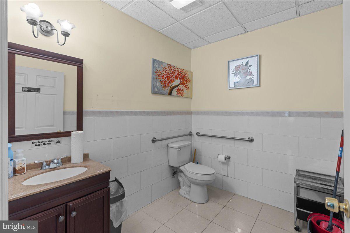 94 East Browning Road Bellmawr, NJ 08031 - Photo 12 of 39 a bathroom with a toilet a sink and mirror