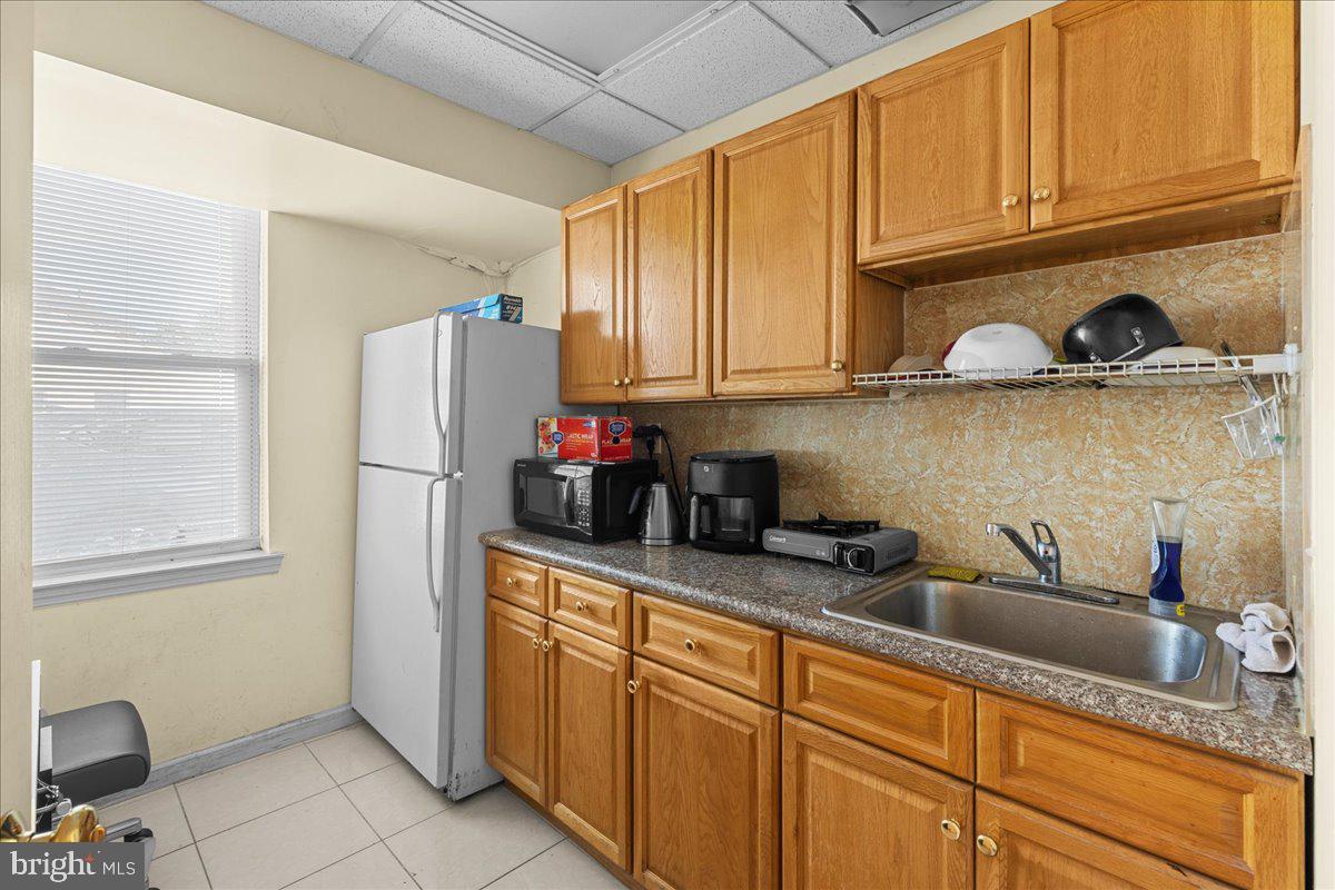 94 East Browning Road Bellmawr, NJ 08031 - Photo 13 of 39 a kitchen with stainless steel appliances granite countertop a refrigerator sink and cabinets