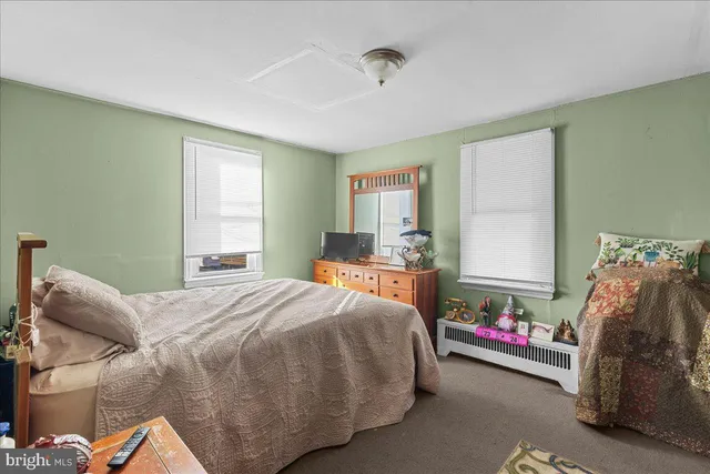 a living room with furniture a flat screen tv and a table
