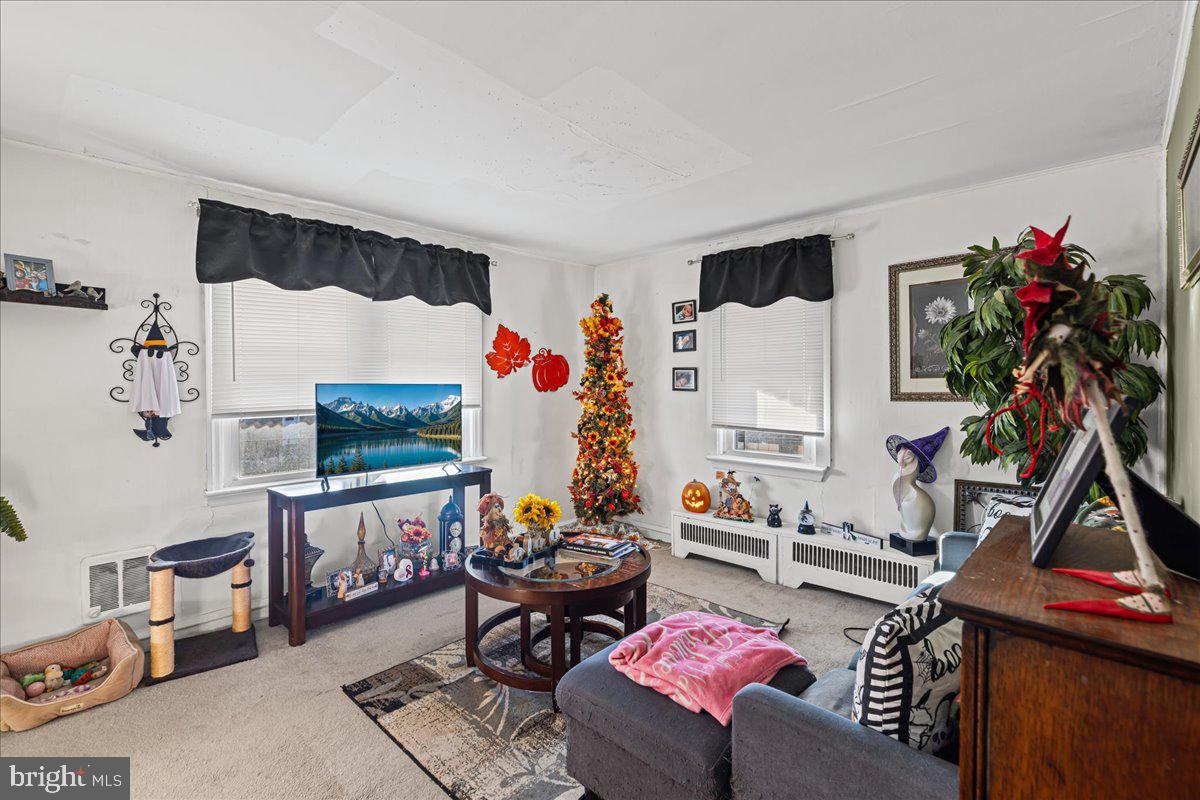 94 East Browning Road Bellmawr, NJ 08031 - Photo 16 of 39 a living room with furniture a flat screen tv and a table