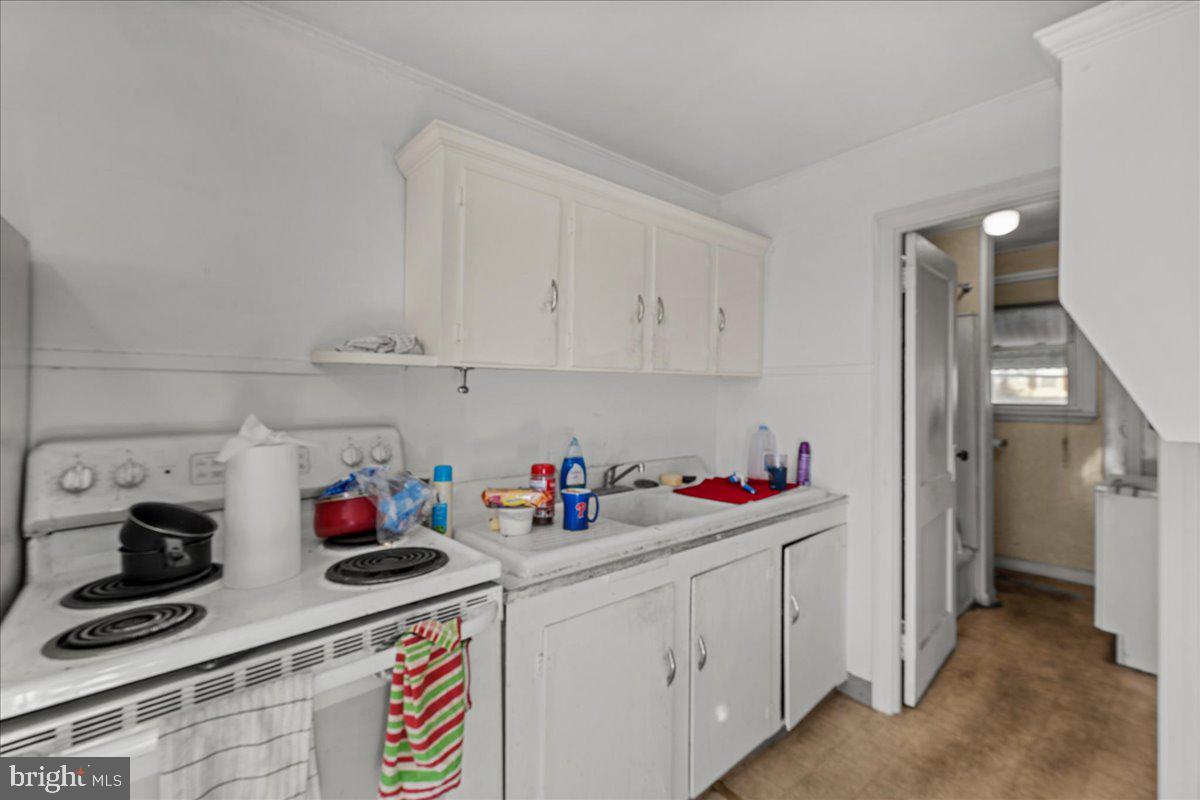 94 East Browning Road Bellmawr, NJ 08031 - Photo 21 of 39 a kitchen with a sink and cabinets
