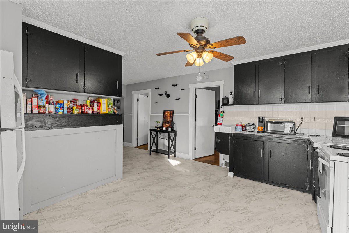 94 East Browning Road Bellmawr, NJ 08031 - Photo 25 of 39 a view of a kitchen with fridge and workspace