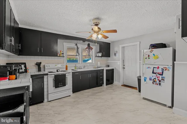 a bathroom with a sink a toilet and shower curtain