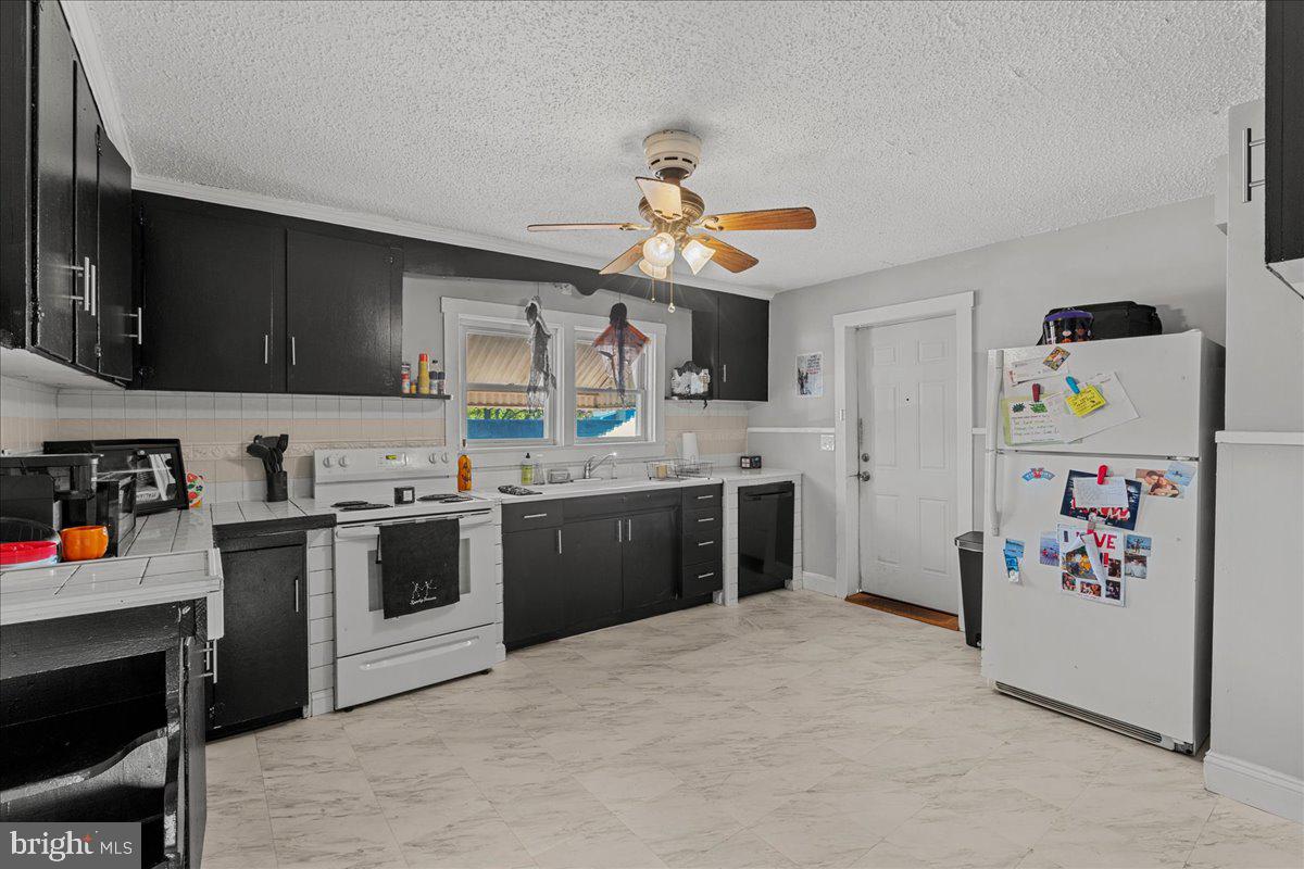 94 East Browning Road Bellmawr, NJ 08031 - Photo 26 of 39 a kitchen with granite countertop a white stove top oven and cabinets