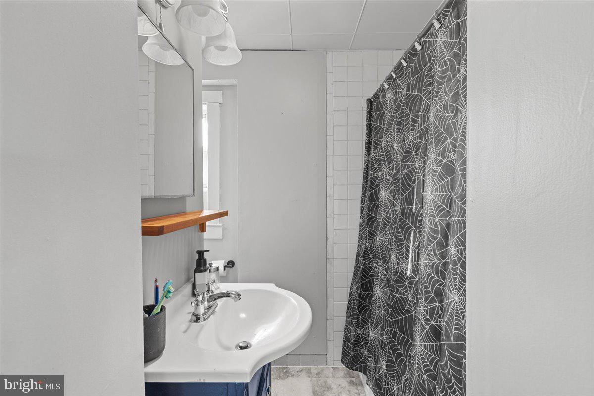 94 East Browning Road Bellmawr, NJ 08031 - Photo 28 of 39 a bathroom with a sink a toilet and shower curtain