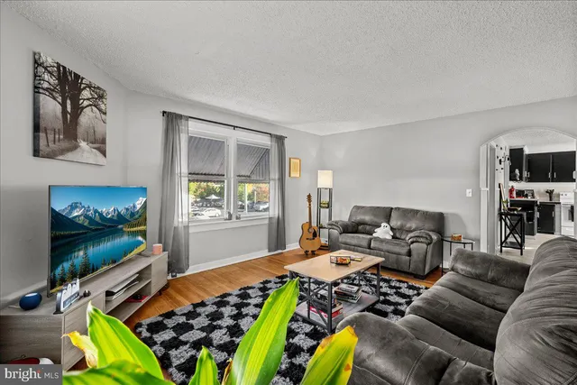 a living room with lots of furniture and a chandelier
