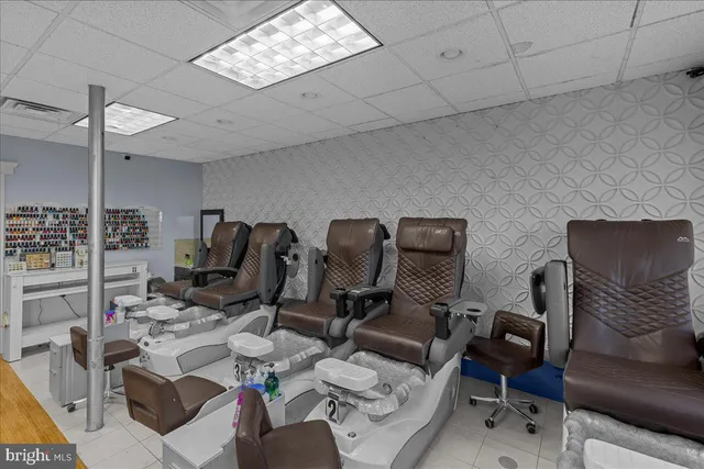 a view of a workspace with furniture and a kitchen