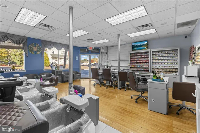 a view of a workspace with furniture and a window