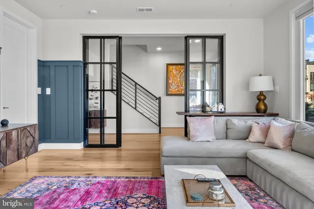 a living room with furniture large window and flat screen tv