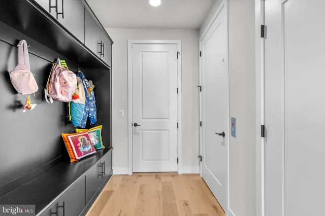 a dining room with stainless steel appliances kitchen island granite countertop a table chairs and a living room