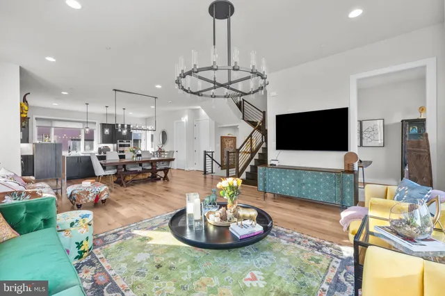 a living room with lots of furniture and a chandelier