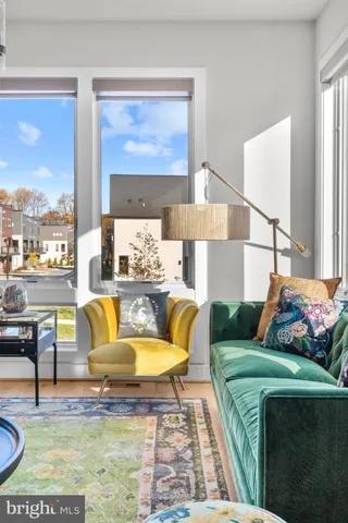 a kitchen with stainless steel appliances kitchen island granite countertop a sink a stove and a wooden floor