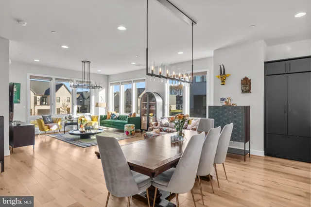 a view of a patio with dining table and chairs with wooden floor and fence