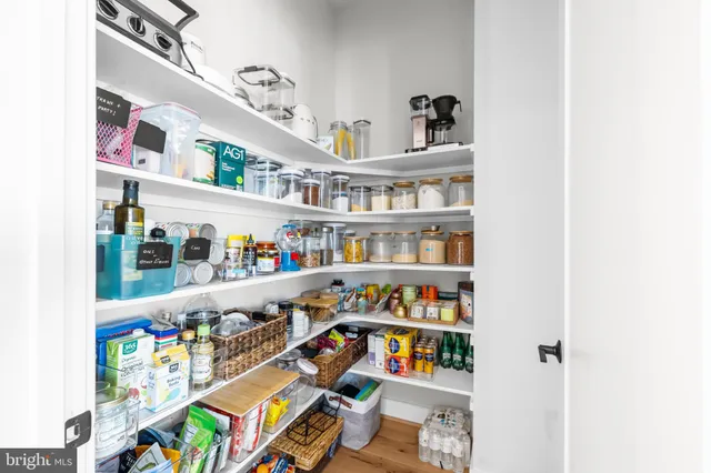 a spacious bedroom with a bed couch and windows