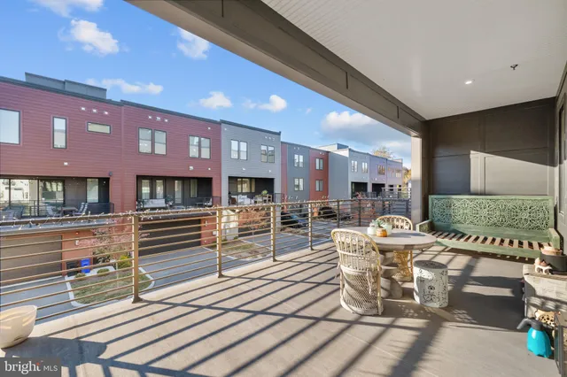 a view of a hallway with wooden floor and stairs