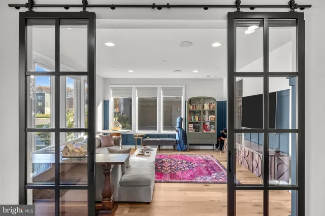 a living room with furniture and a chandelier