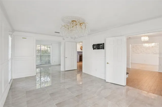 an empty room with fireplace and windows