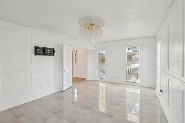 an empty room with a ceiling fan and carpet