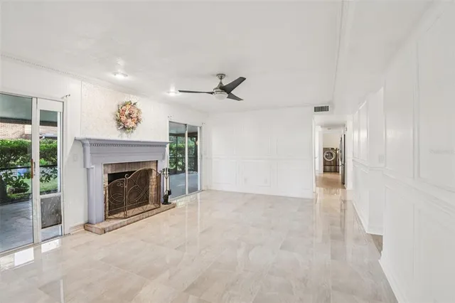 an empty room with chandelier fan