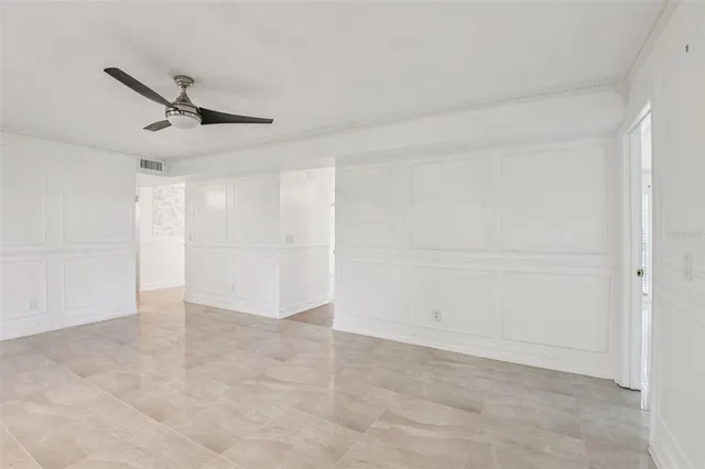 an empty room with fireplace and windows
