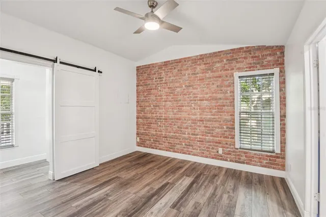 a spacious bathroom with a granite countertop sink mirror vanity and bathtub