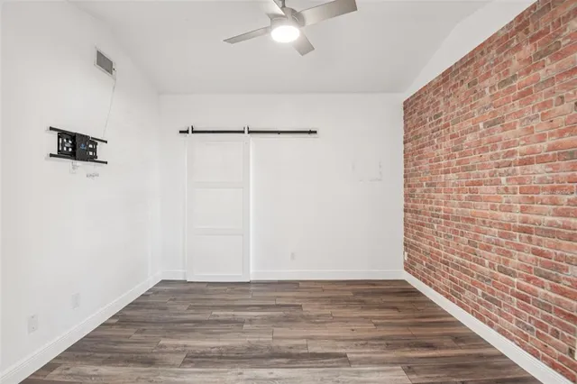 a spacious bathroom with a granite countertop sink a toilet a mirror and shower