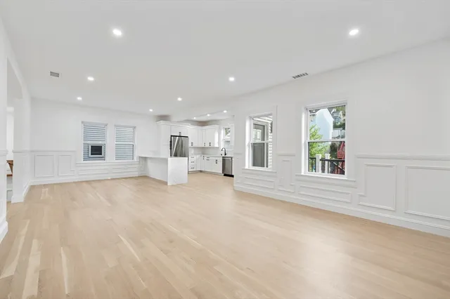a kitchen with stainless steel appliances granite countertop a refrigerator and a stove top oven