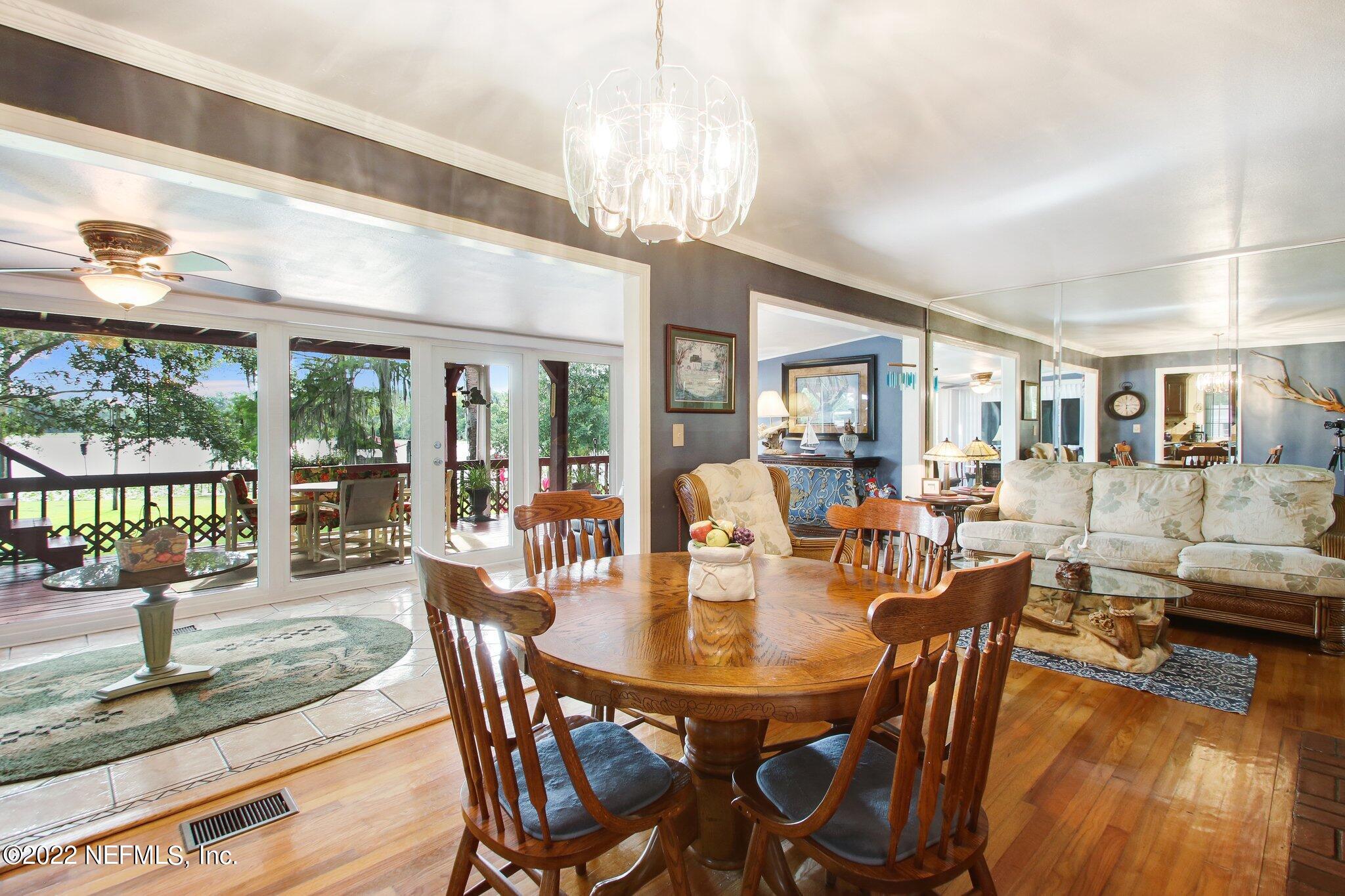 101 Orange Street Satsuma, FL 32189 - Photo 12 of 67 a dining room with furniture a chandelier and wooden floor
