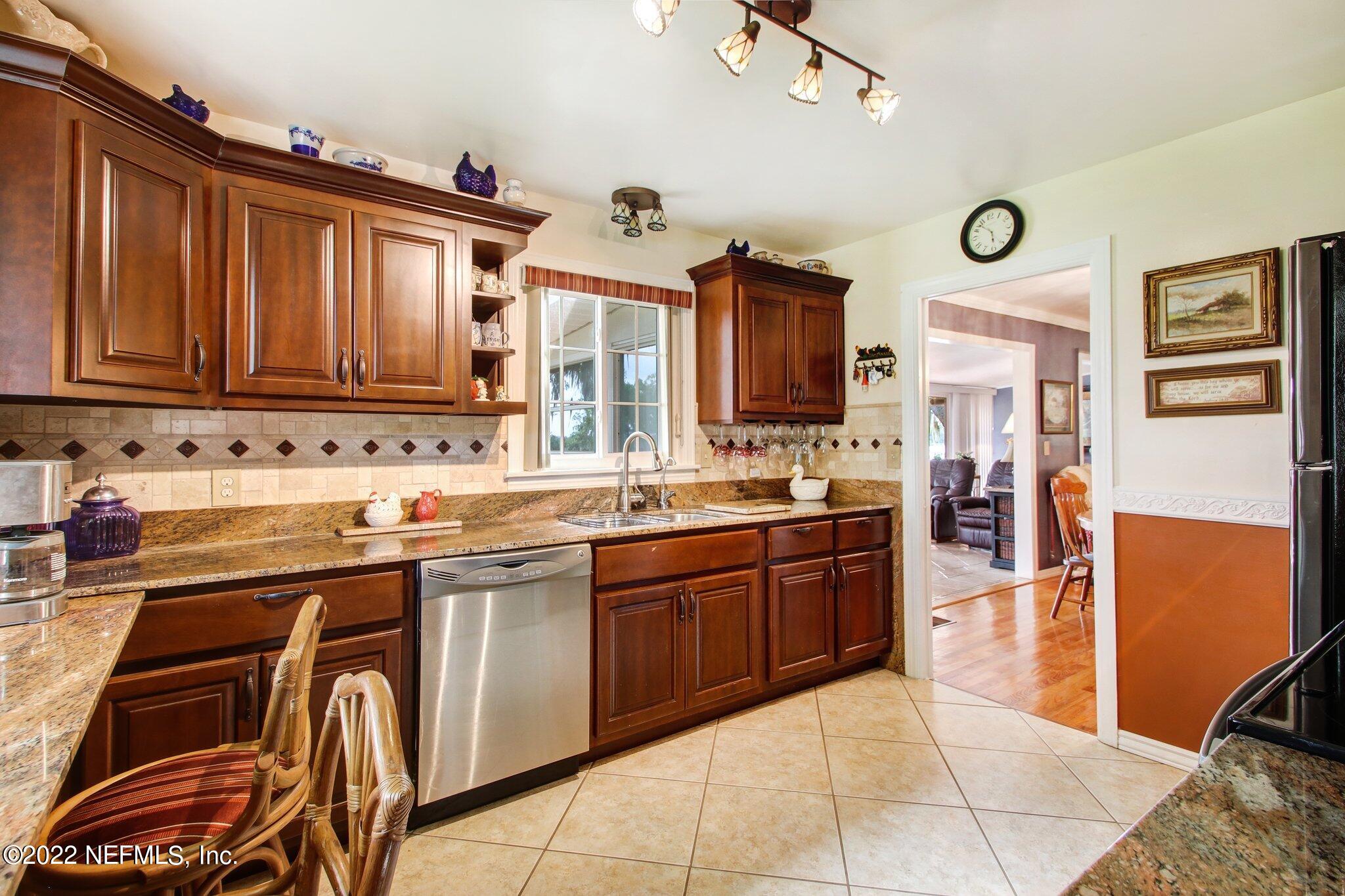 101 Orange Street Satsuma, FL 32189 - Photo 15 of 67 a kitchen with stainless steel appliances granite countertop a sink and cabinets