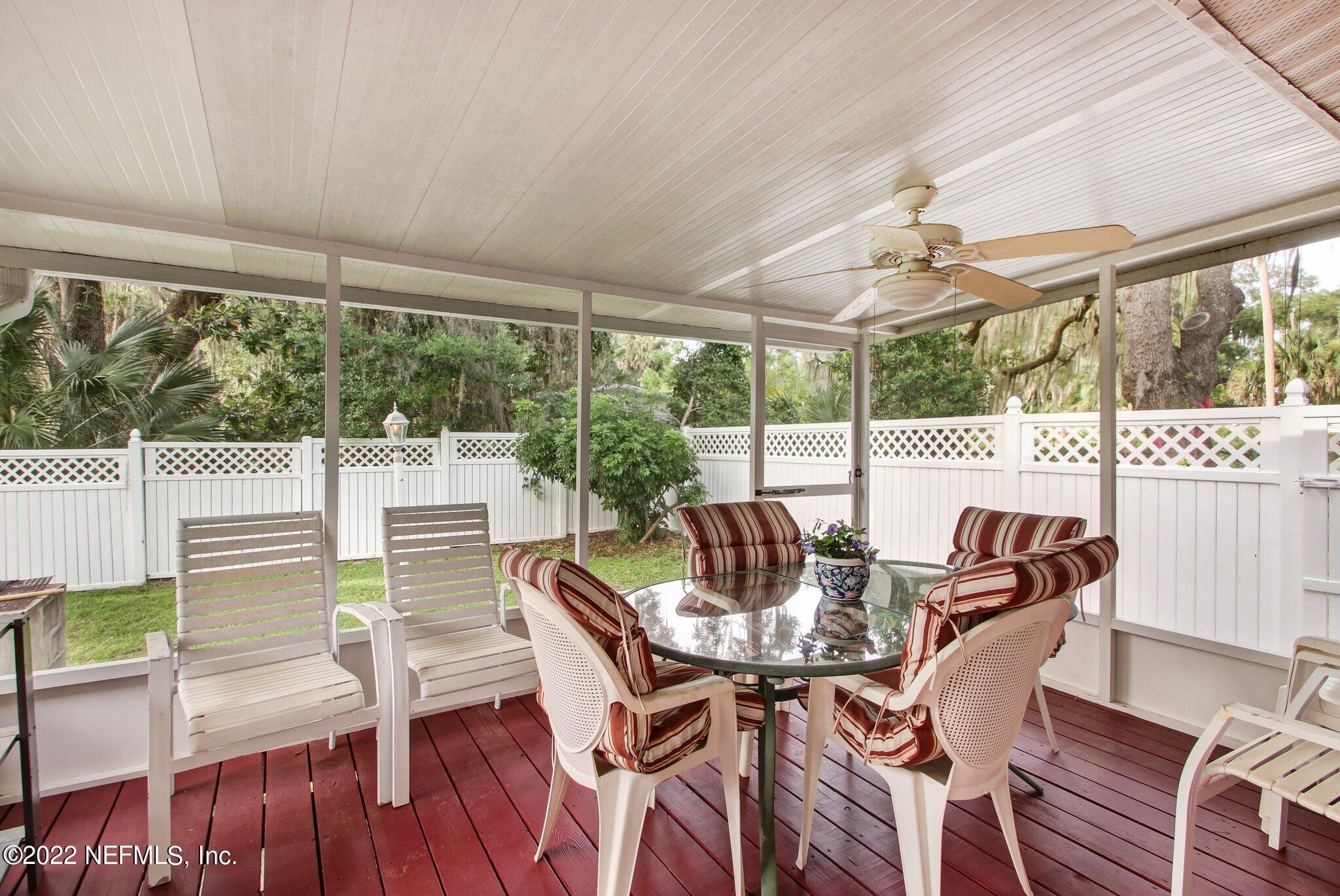 101 Orange Street Satsuma, FL 32189 - Photo 23 of 67 a view of a dining room with furniture large windows and wooden floor