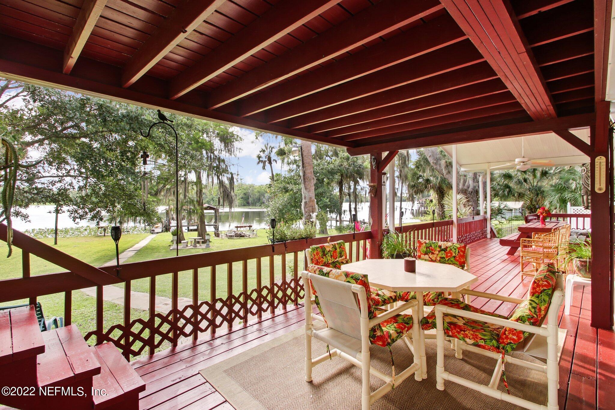 101 Orange Street Satsuma, FL 32189 - Photo 27 of 67 a view of a patio with table and chairs and wooden floor