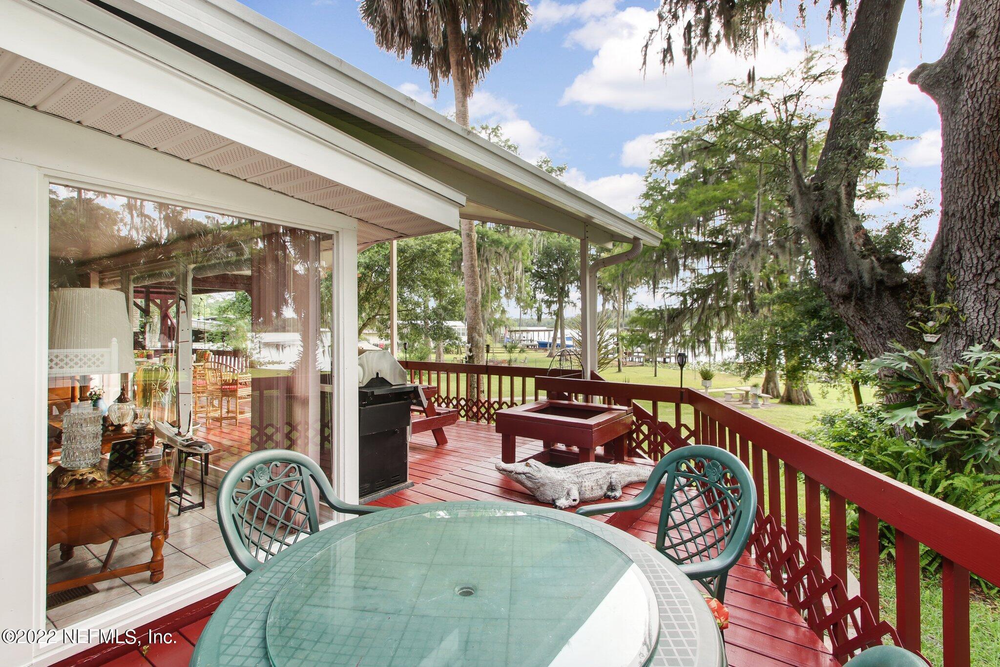 101 Orange Street Satsuma, FL 32189 - Photo 32 of 67 a balcony with furniture and potted plants