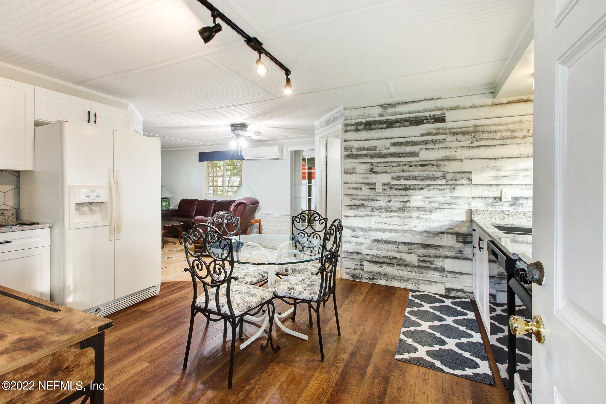 101 Orange Street Satsuma, FL 32189 - Photo 37 of 67 a view of a dining room with furniture and wooden floor